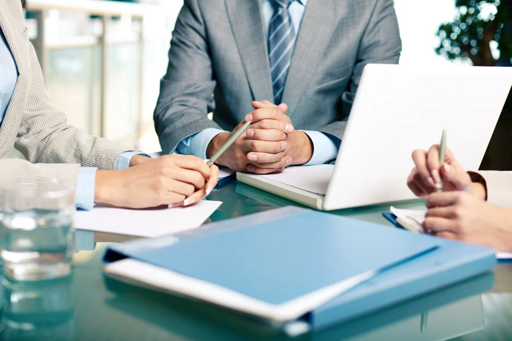 Image of a business owner analyzing financial documents, representing the preparation and financial management involved in a business exit.