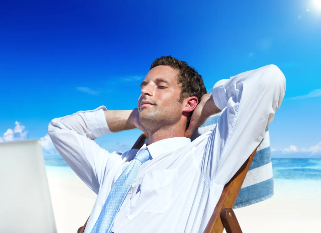 Image of a businessman relaxing at the beach after a successful business exit